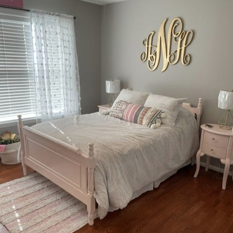 Bedroom with a bed, nightstands, and decorative wall letters.