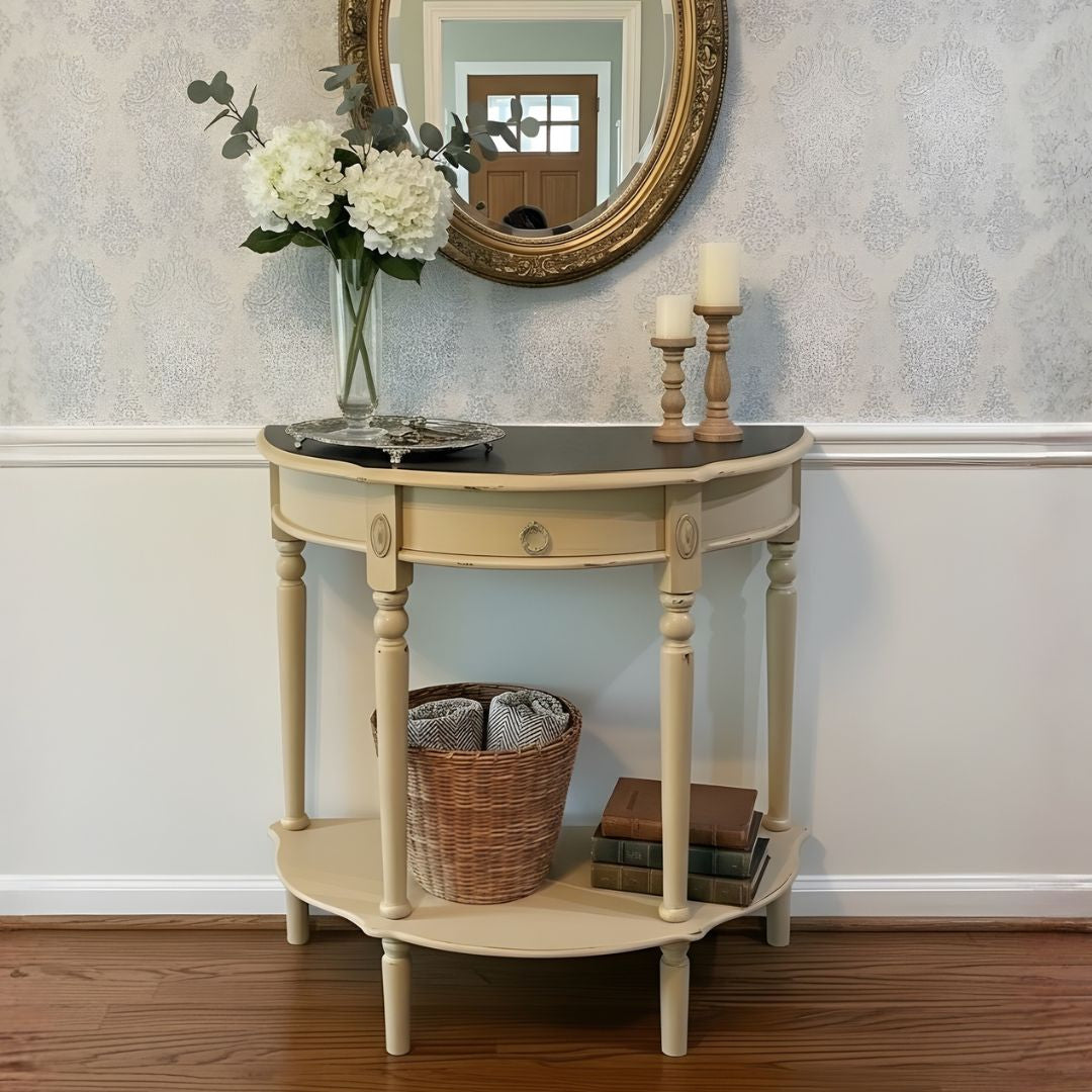 Small round table with decorative items against a wall with a mirror.