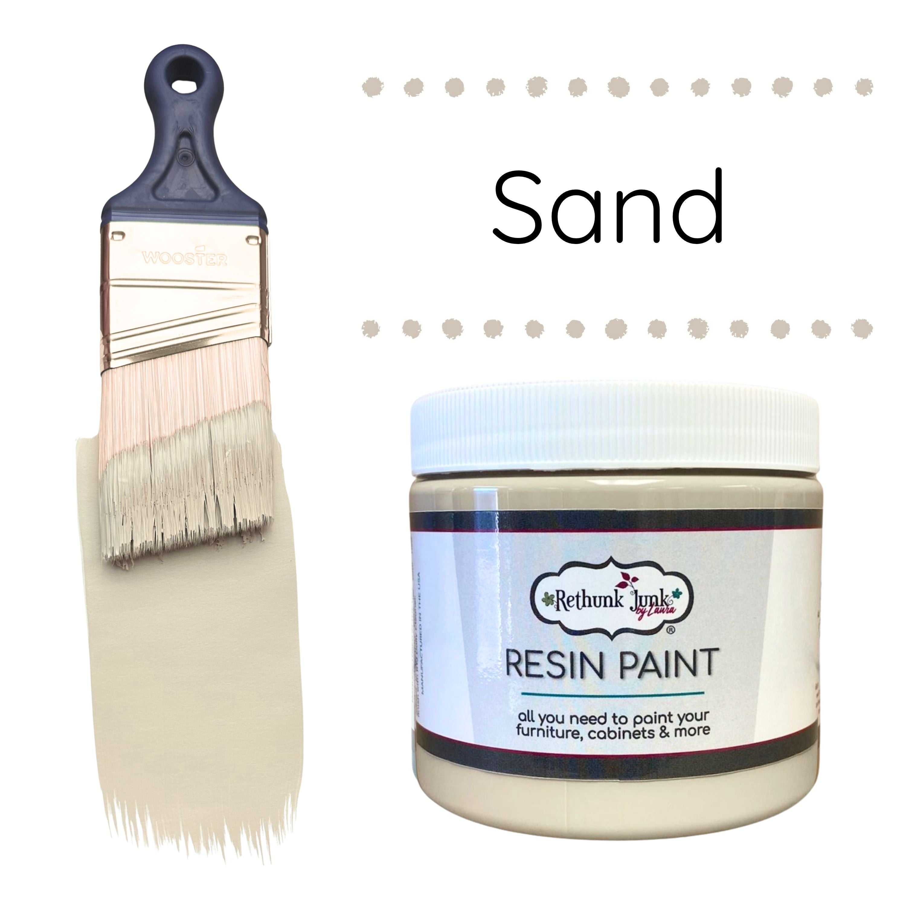 Resin paint jar with a brush labeled 'Sand' on a white background